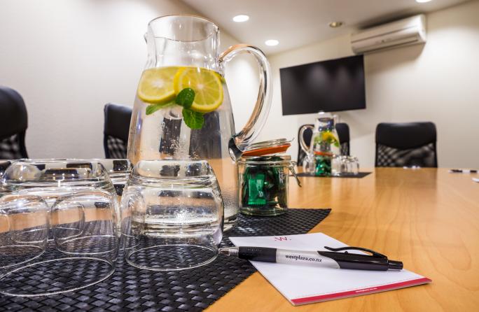 Boardroom table with glasses and lemon water